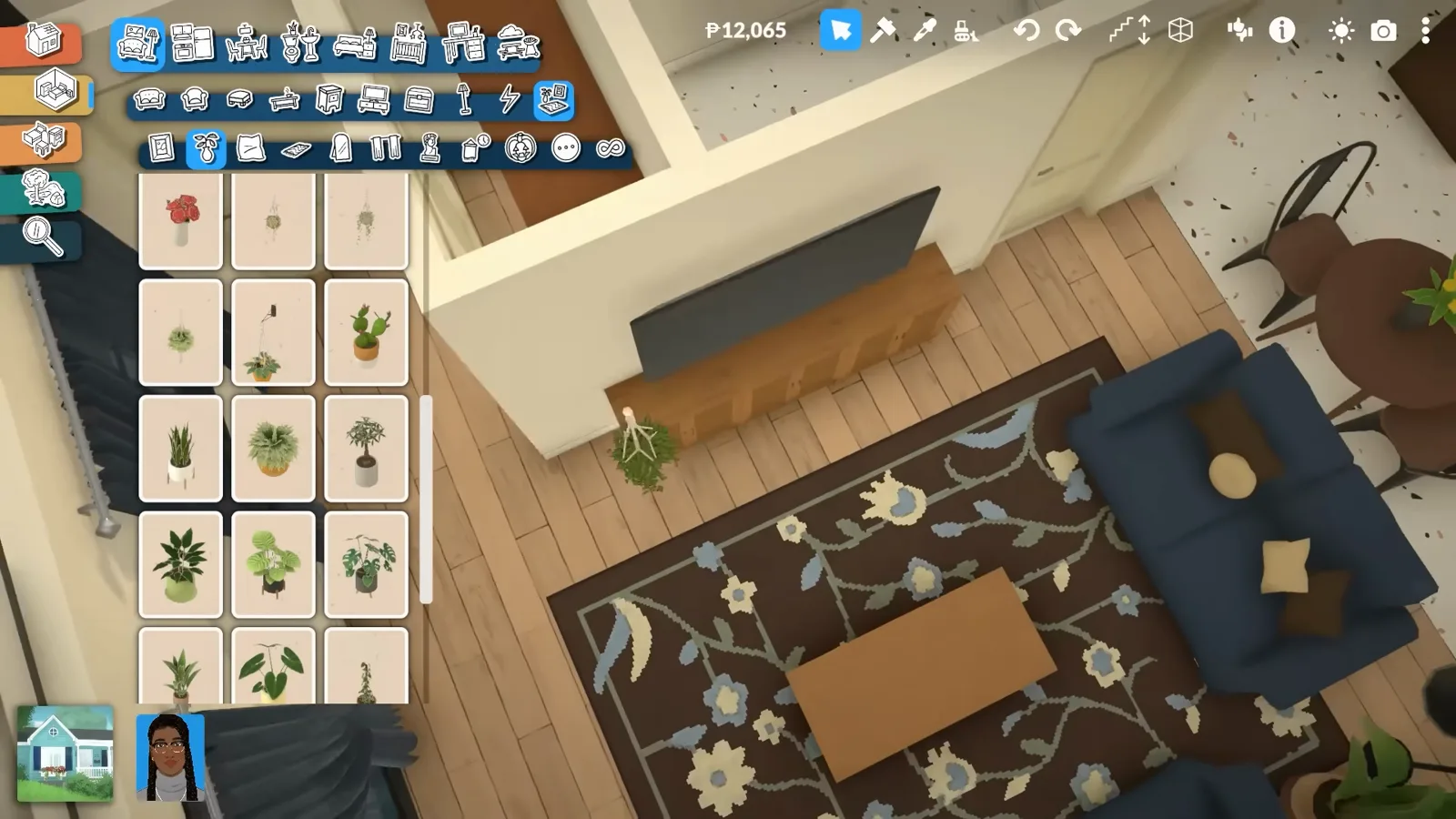 A finished Paralives living room with a TV on a wooden stand, navy sofas, a hanging plant and books stacked on the coffee table over the patterned rug