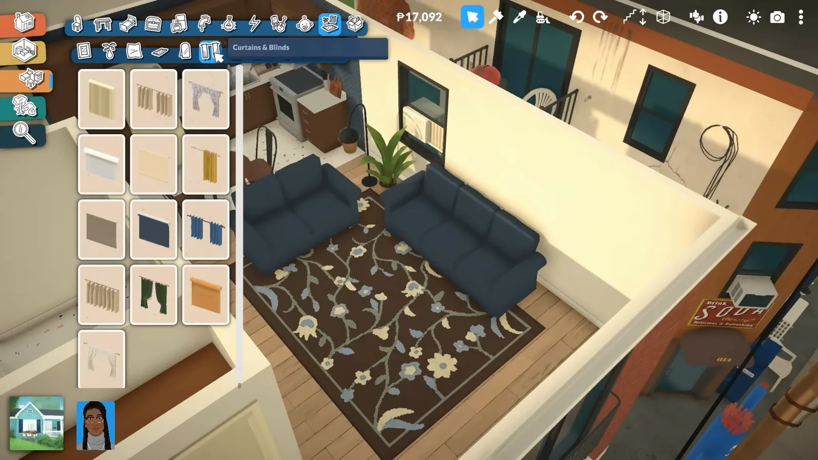 A patterned brown and blue rug placed under the navy sofas in a Paralives living room with the rug catalogue still open