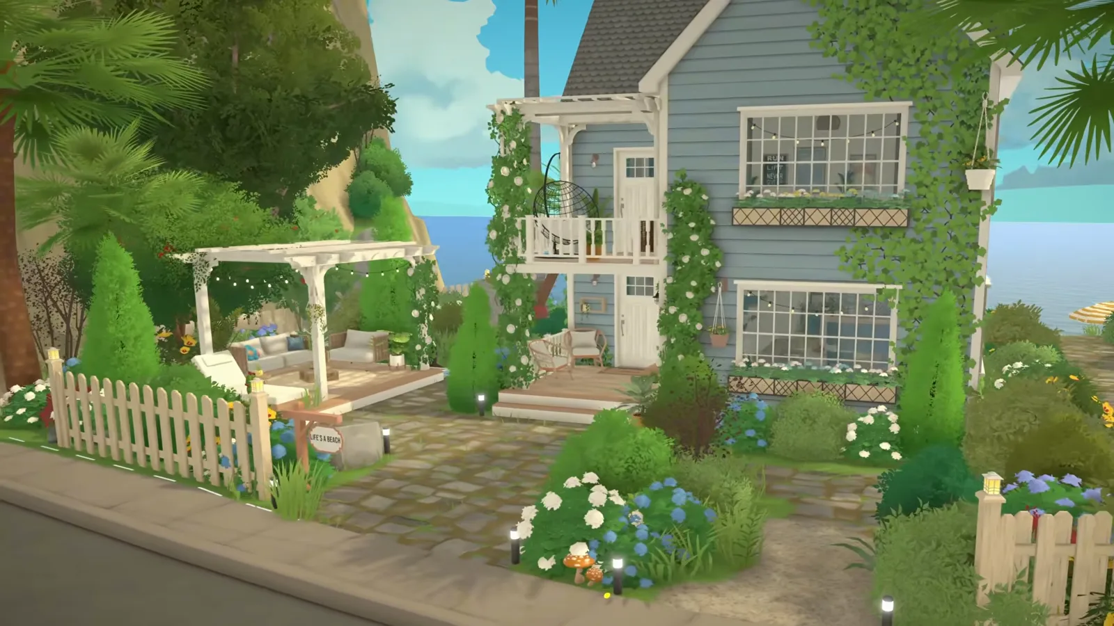 A finished Paralives beach house with blue-gray clapboard, white trim and climbing vines seen from the street, behind a white picket fence with a pergola and a flowering front garden A finished Paralives beach house with blue-gray clapboard, white trim and climbing vines seen from the street, behind a white picket fence with a pergola and a flowering front garden