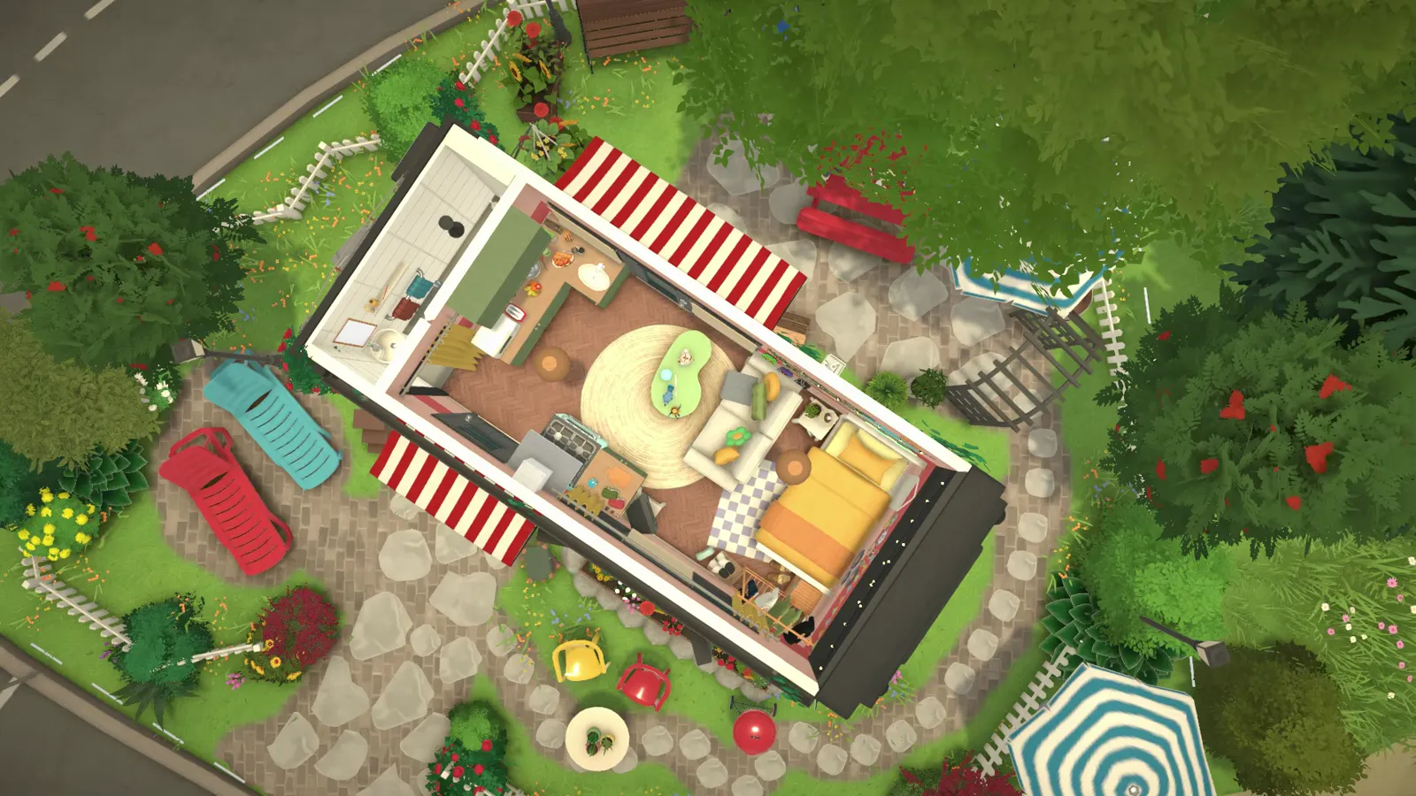 Paralives' roofless dollhouse view shows the camper plot from above — kitchen, bed, striped awnings and the stone-path loop in one frame.