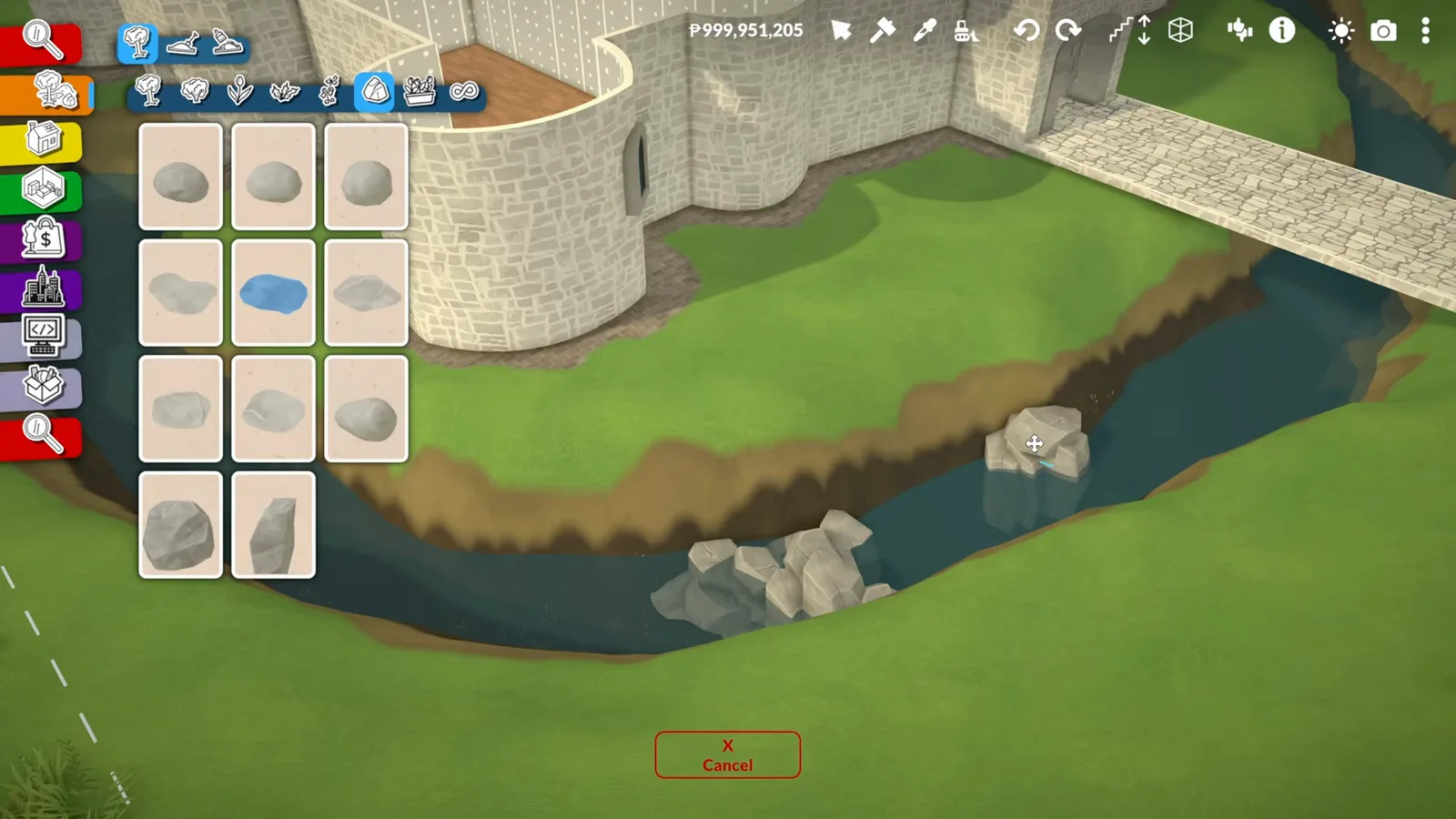 Water-filled Paralives castle moat with boulders in the shallows and a flat stone bridge crossing to the gatehouse
