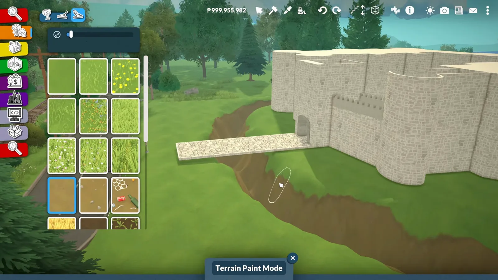 Paralives terrain tools cutting a dry moat channel around a stone castle curtain wall with a causeway strip left uncut