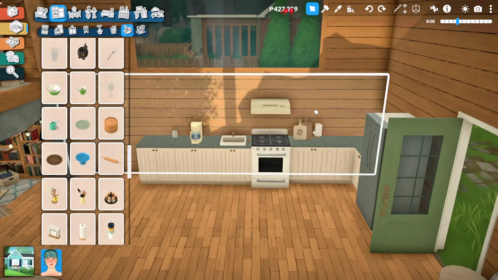 A compact Paralives kitchen with white counters, a stove and a green cabinet under a wooden loft platform.