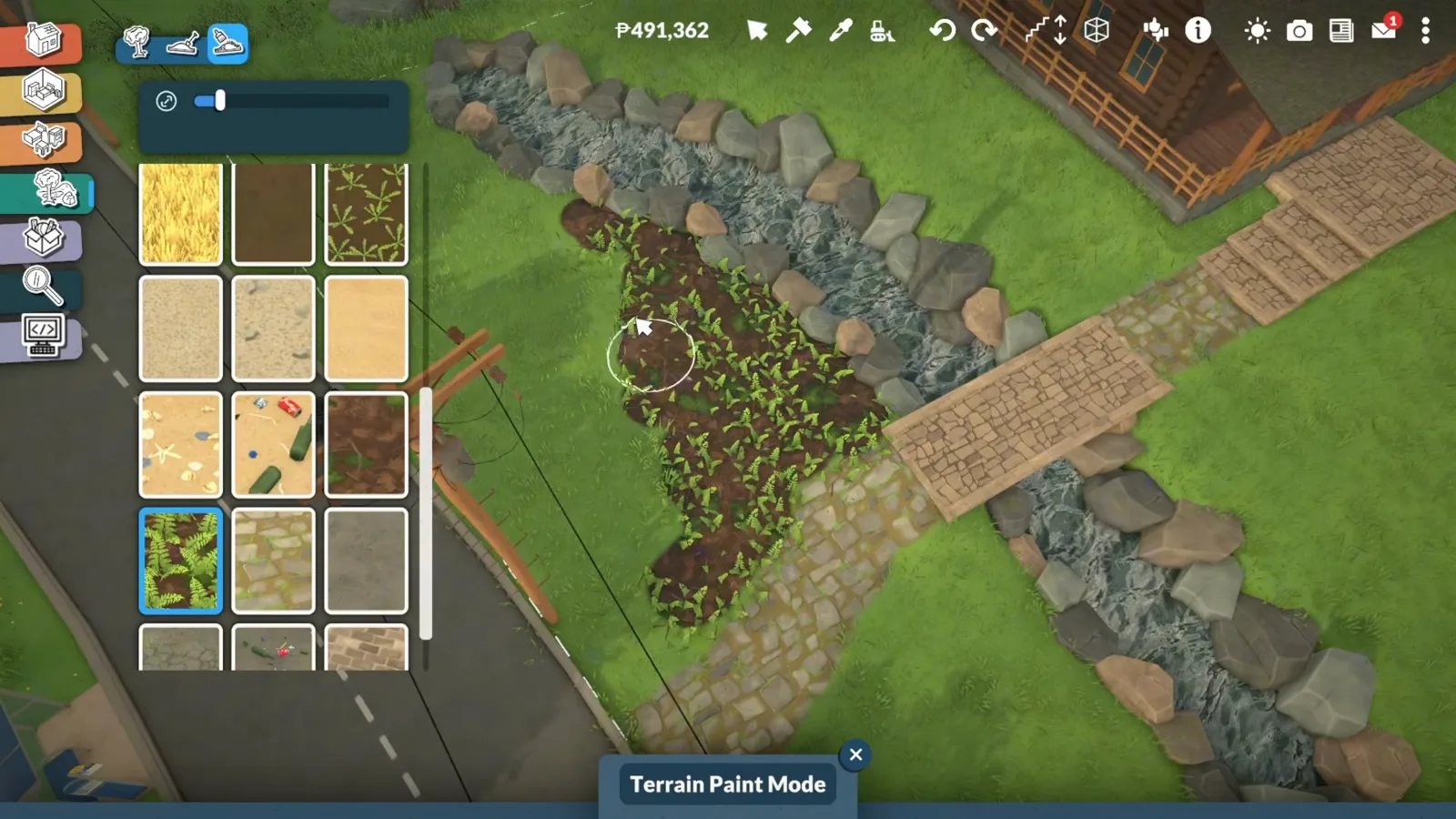 Terrain Paint Mode in Paralives with the forest ground swatch selected, painting dark woodland soil around a log cabin path.