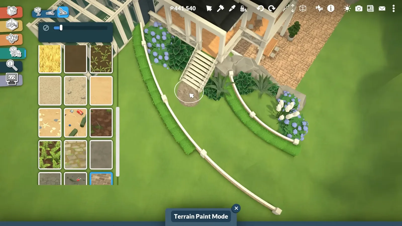 Terrain Paint Mode swatches open while stone pavers are painted onto the sculpted terrace of a Paralives mansion
