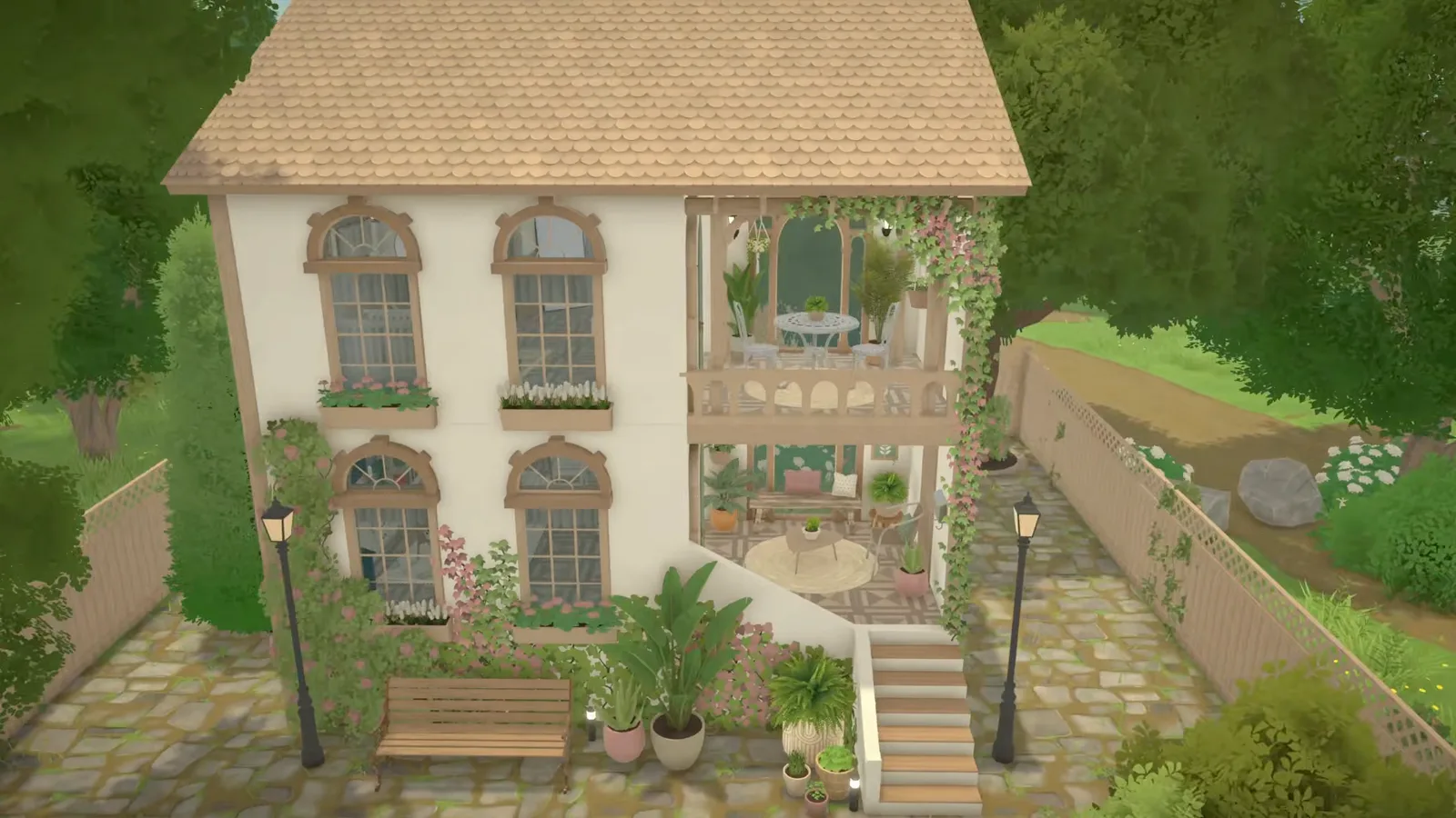 Aerial view of a finished Paralives Mediterranean-style house with white stucco walls, arched windows with flower boxes, climbing vines, two open-air terraces and a light scalloped tile roof. Aerial view of a finished Paralives Mediterranean-style house with white stucco walls, arched windows with flower boxes, climbing vines, two open-air terraces and a light scalloped tile roof.