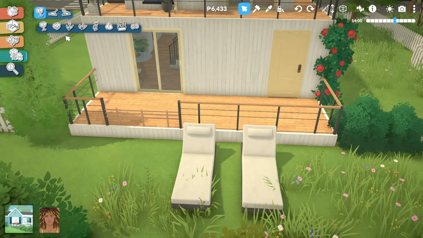 Paralives back garden with two white loungers on the grass beside a deck with black railing and a climbing rose on the post