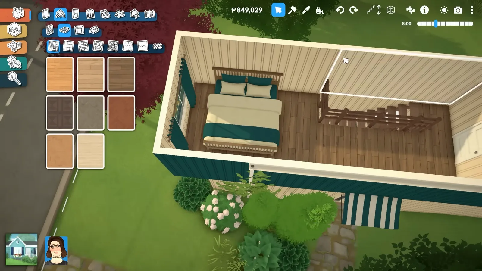 Top-down view of a Paralives container bedroom with a teal-bedded bed, timber flooring and the staircase landing beside corrugated walls.