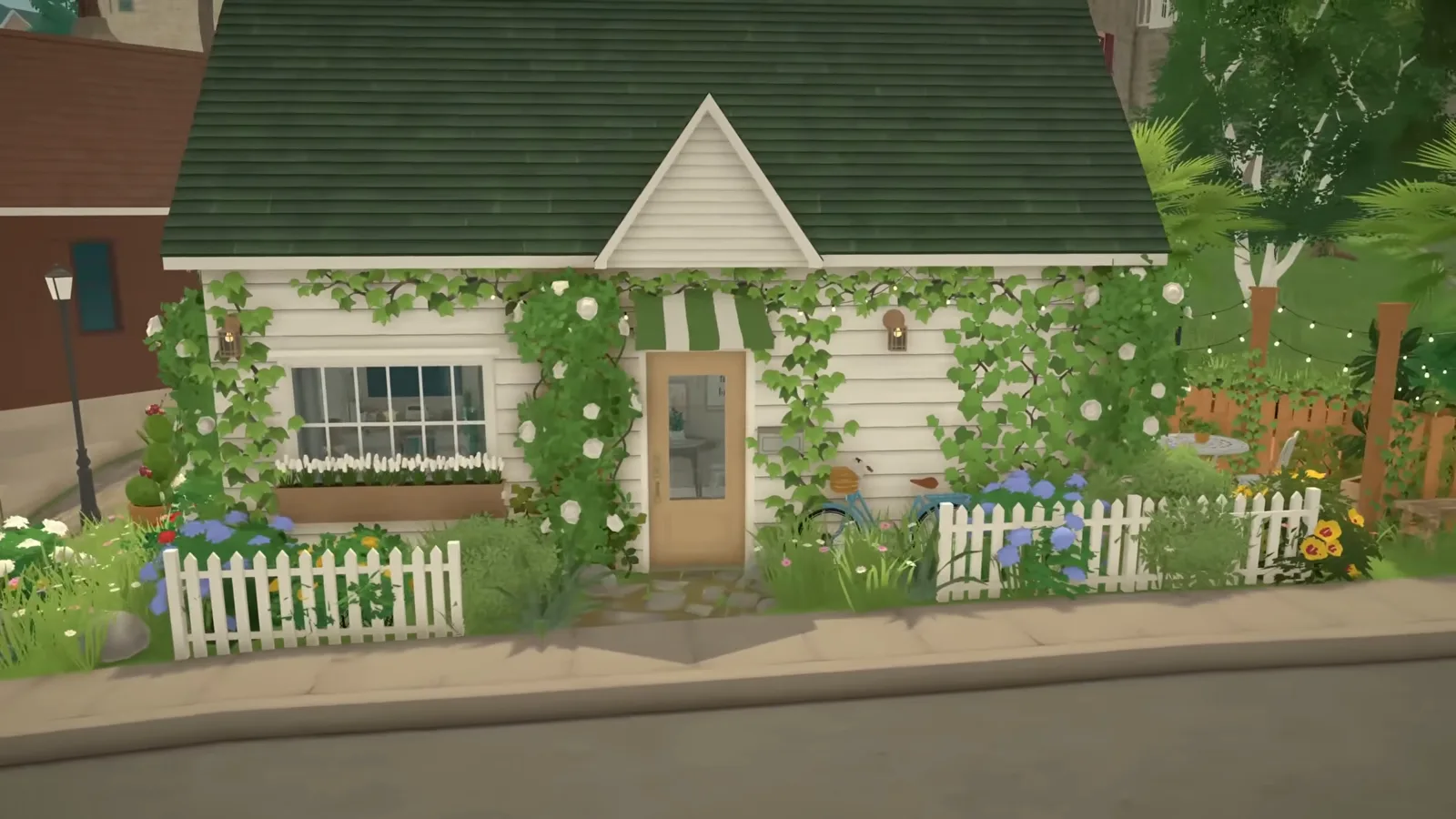 A finished Paralives tiny house with a green roof, climbing vines, a striped awning over the door and a white picket fence along the street